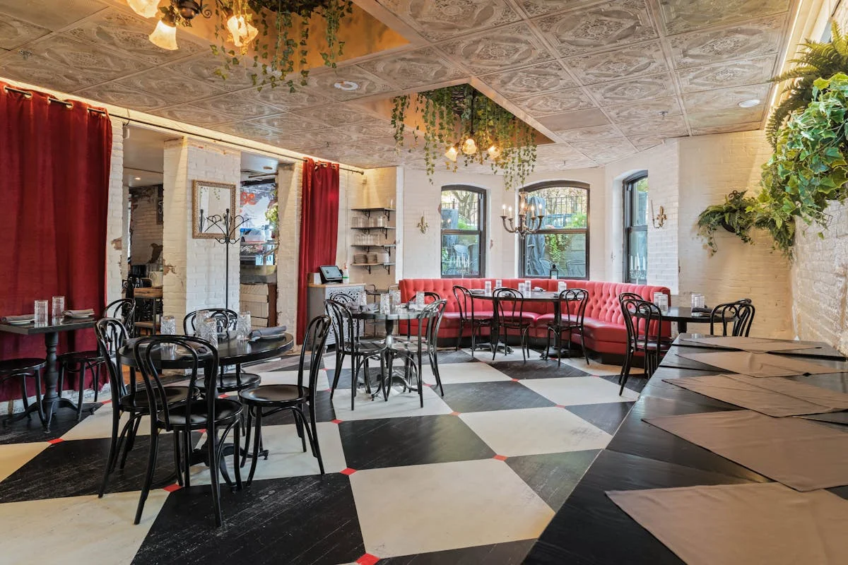 Charming restaurant interior with red seating and checkered floor