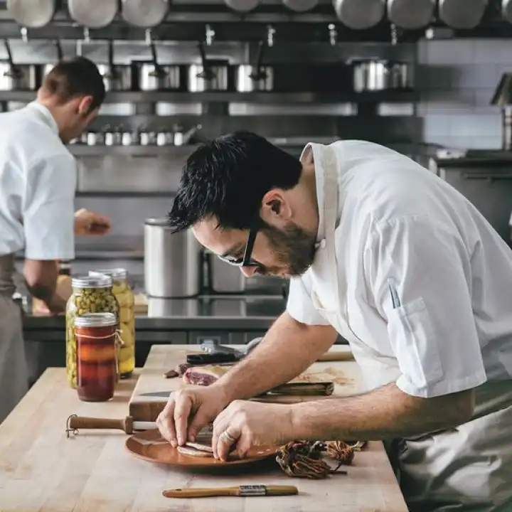 A restaurant chef preparing a dish