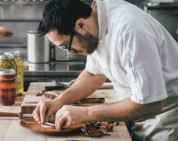 A restaurant chef preparing a dish